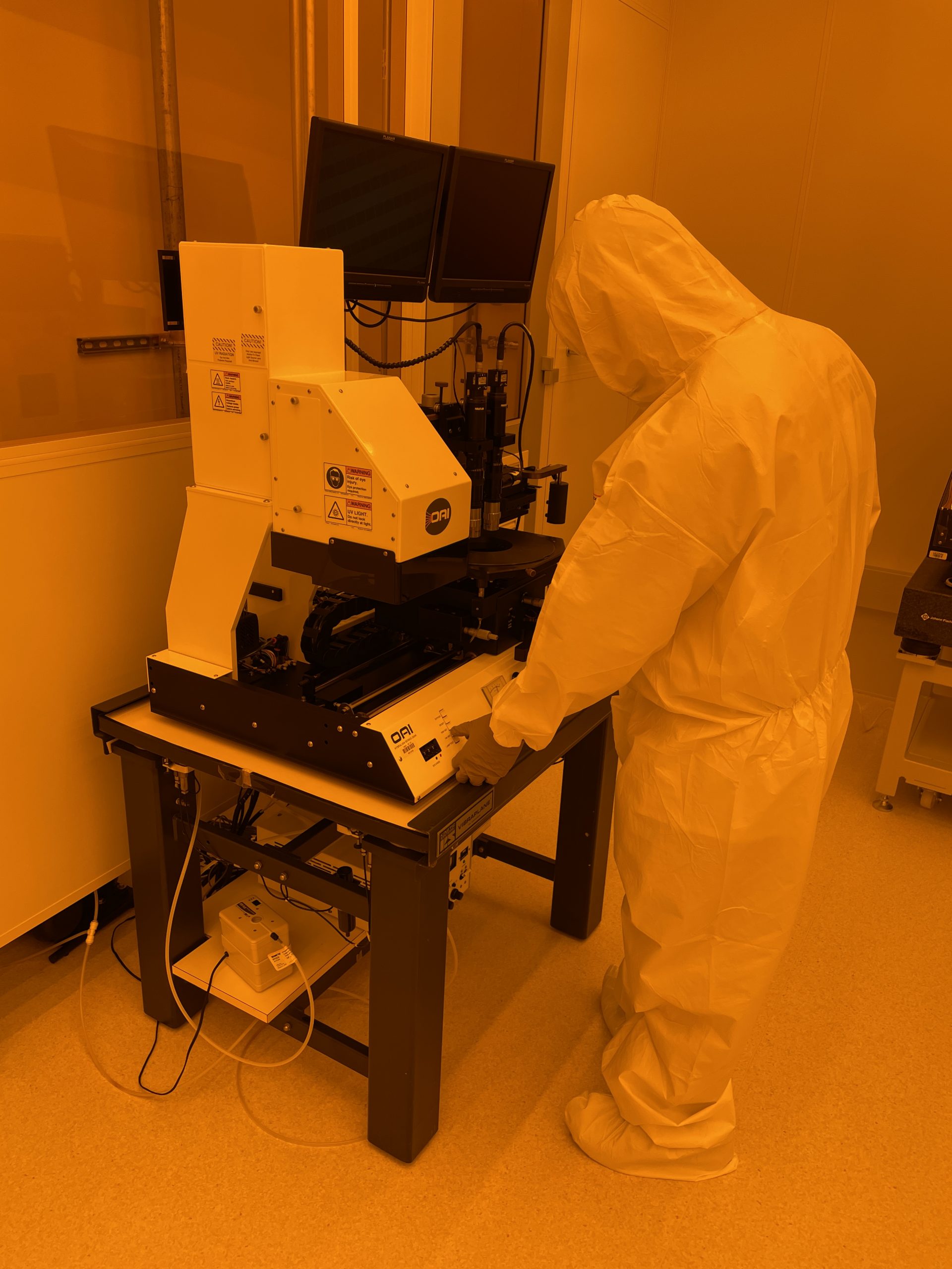 person working at mask aligner in cleanroom bay 4